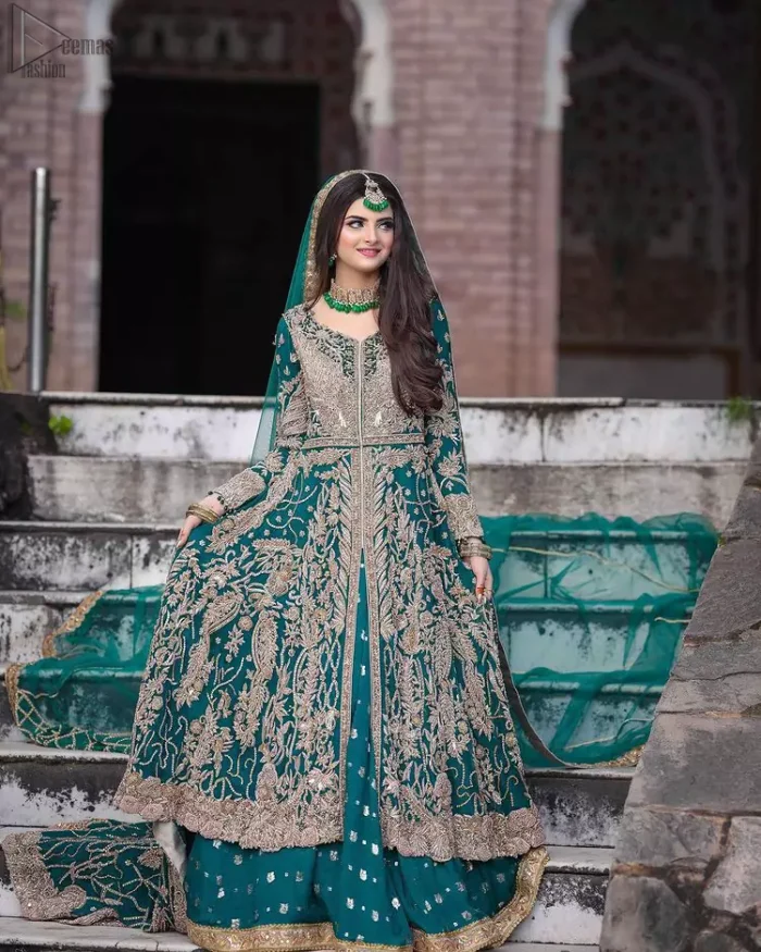 This breathtaking fit and flare wedding dress offers comfort without compromising on style. Featuring beautiful handwork, this outfit has a delicate arrangement of hand-embellished floral patterns with champagne zardozi work along the length. Refined craftsmanship is at its best with a hand embellished belt clenched elegantly at the waistline. It comes with a sea-green lehenga adorned with tiny motifs spray all over the ground and exaggerated with embroidered lace bottom. This outfit is paired up with an organza dupatta with embroidered border to give it a perfect ending.