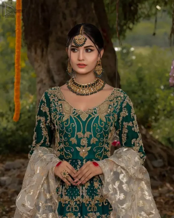 The new season is all about making a statement. Unique craftsmanship and detailed embellishments bring heavenly hued gossamer fabrics to life. Add a charm to your mehndi with an intricately golden embellished bodice and motifs all around the flare on sea green canvas of organza. Daaman is elegantly decorated with embroidered golden floral bootis, sprinkled sequins and beautiful craftsmanship. Pair it up with sea-green sharara having delicate details at the bottom instantly draws attention. To complete the look, go with ivory brocade dupatta.