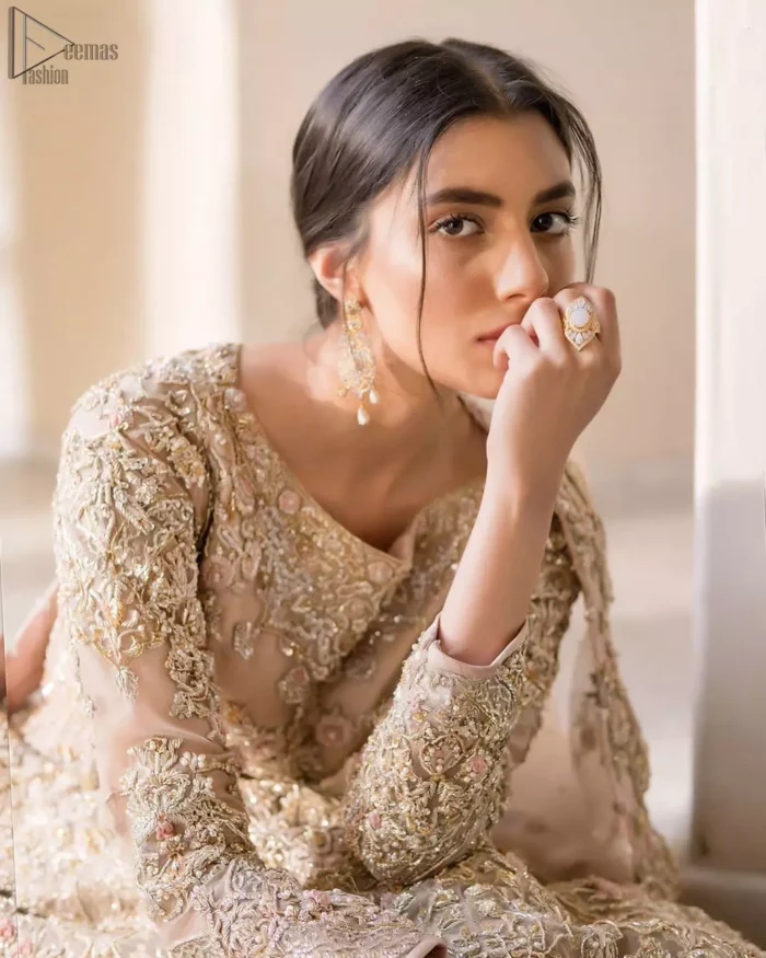 Picturing your bridal in a tea rose colour? This subtleness laden with ornamental embellishments and embroidery creates such a fairytale touch to your wedding. The boat-shaped blouse is emphasized with light golden zardozi work and finished with dangling pearls. Paired up with matching lehenga creates an unusual charisma wholeheartedly. Featuring beautiful handwork and a delicate arrangement of hand-embellished floral patterns with zardozi work along the length of lehenga. Refined craftsmanship is at its best with a hand embellished dupatta. The dupatta incorporates beautifully designed borders on all four sides, focusing on the heavily embellished pallu borders to give it a perfect maharani look.