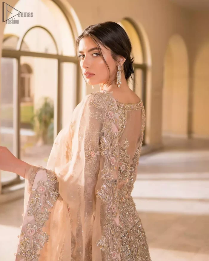 Picturing your bridal in a tea rose colour? This subtleness laden with ornamental embellishments and embroidery creates such a fairytale touch to your wedding. The boat-shaped blouse is emphasized with light golden zardozi work and finished with dangling pearls. Paired up with matching lehenga creates an unusual charisma wholeheartedly. Featuring beautiful handwork and a delicate arrangement of hand-embellished floral patterns with zardozi work along the length of lehenga. Refined craftsmanship is at its best with a hand embellished dupatta. The dupatta incorporates beautifully designed borders on all four sides, focusing on the heavily embellished pallu borders to give it a perfect maharani look.