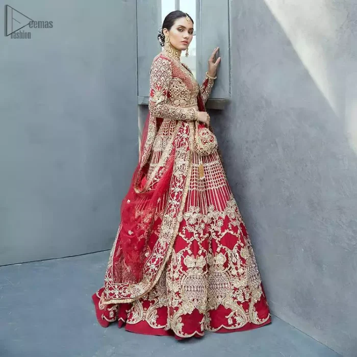 A bride wants to feel as beautiful as she is on her special day and knowing that our outfit was the final decision that, it is priceless. This handcrafted remarkable ensemble reflects the aura of the heavenly blouse and includes art deco design elements. The boat-shaped neckline of the blouse is beautifully handcrafted with zardozi work and vertical lines enhanced with beads on it. Complete the look with an artfully coordinated lehenga which is ornamented with a bold and captivating design with traditional intricate embroidery. Style it up with a red dupatta having four-sided embroidered borders and Kiran on it.