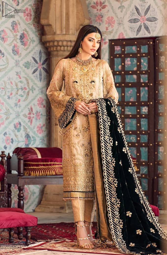The beige pure organza shirt has been appliqued with black velvet on cuffs and on the hemline. This straight shirt comes with pure banarsi jamawar cigarette Pants. Dupatta is like a shawl in velvet a perfect combination for Nikah n Engagement.