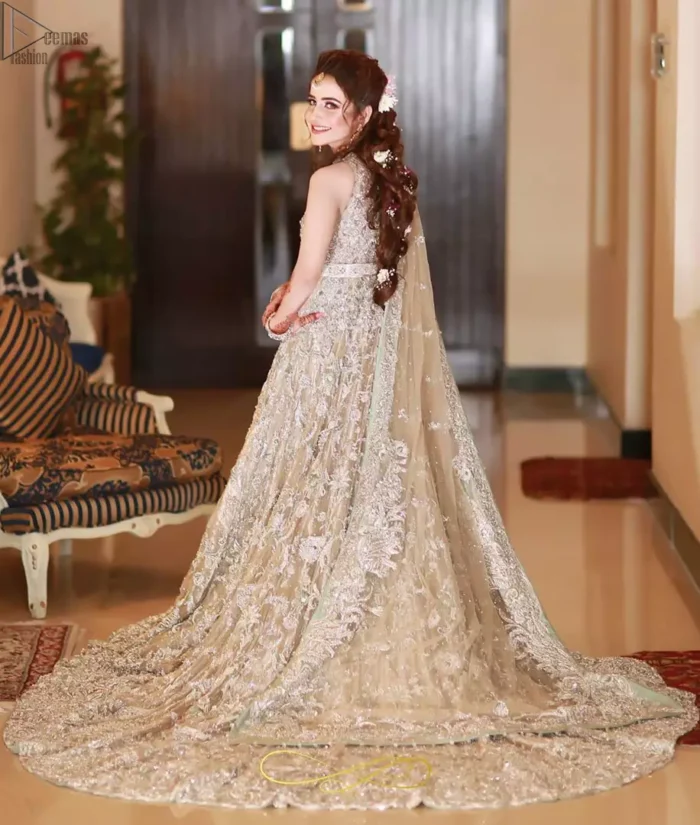 Your graceful personality demands a royal touch, which is why the Fawn Back Train Maxi ensures imperial distinctiveness. As per its highly admirable looks, this exquisite bridal wear is made sleeveless and adorned with exemplary silver embroidery to give it the most majestic vibes. Dresses for whom uniqueness prevails, a halterneck works outstandingly as an icing on a cake. Pure organza is chosen as the graceful fabric for the maxi, whereas the churidar pajama is made with the smoothest raw silk. Not to forget, a final add-up of an elegant net dupatta, and this ravishing attire is all set to dazzle up your Walima.