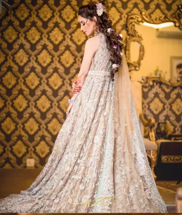 Your graceful personality demands a royal touch, which is why the Fawn Back Train Maxi ensures imperial distinctiveness. As per its highly admirable looks, this exquisite bridal wear is made sleeveless and adorned with exemplary silver embroidery to give it the most majestic vibes. Dresses for whom uniqueness prevails, a halterneck works outstandingly as an icing on a cake. Pure organza is chosen as the graceful fabric for the maxi, whereas the churidar pajama is made with the smoothest raw silk. Not to forget, a final add-up of an elegant net dupatta, and this ravishing attire is all set to dazzle up your Walima.