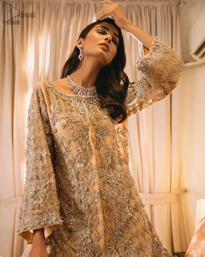 An unforgettable look and ideal for the festive season. An elegant yet trendy front open style makes this outfit more classy. Crafted artfully with detailed zardozi work and illusion neckline finessed with kora, dabka, and Kundan. The motifs and intricate details are a true example of decorative and ornamental expression stylized in a contemporary way. The bell sleeves make this outfit more classy. Balance the look with banarsi lehenga highlighted with embroidered borders at the bottom. The dupatta is enhanced with embroidered pallu.