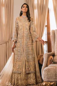 An unforgettable look and ideal for the festive season. An elegant yet trendy front open style makes this outfit more classy. Crafted artfully with detailed zardozi work and illusion neckline finessed with kora, dabka, and Kundan. The motifs and intricate details are a true example of decorative and ornamental expression stylized in a contemporary way. The bell sleeves make this outfit more classy. Balance the look with banarsi lehenga highlighted with embroidered borders at the bottom. The dupatta is enhanced with embroidered pallu.