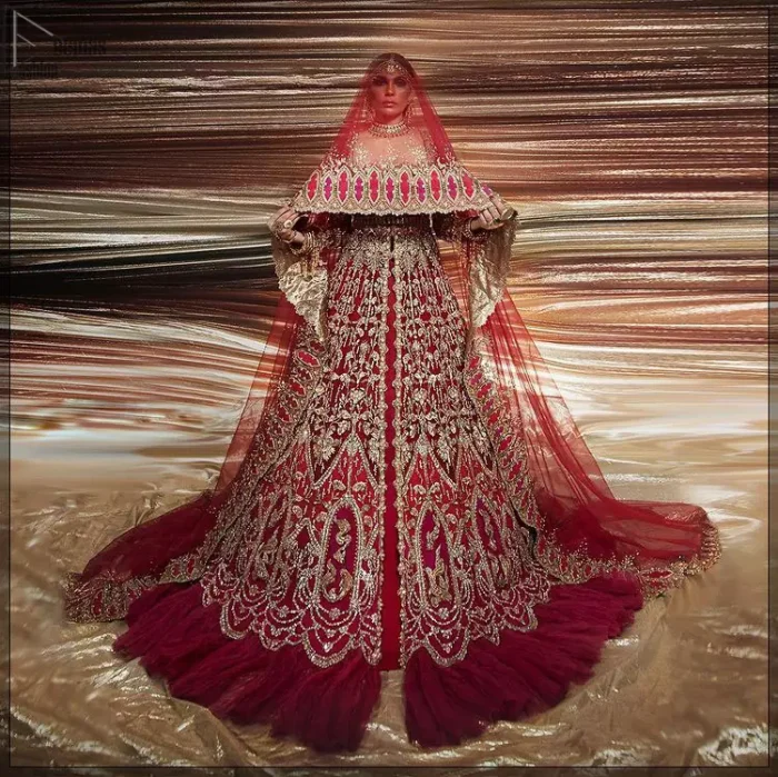 A bride wants to feel as beautiful as she is on her special day, and knowing that our Lehenga was the final decision in that, it is priceless. This bold and iconic bridal ensemble with its dainty flutter silhouette leaves us feeling whimsical, romantic, and even a bit enchanted. This front open pishwas is laden with silver and golden zardozi work, a beautifully crafted waist belt and floral embroidery patterns. The dress is even more enhanced with the ruffled bottom. It is coordinated with a beautiful dupatta with thick matha Patti borders along the length and an intricate beautiful border on the rest of the two sides.