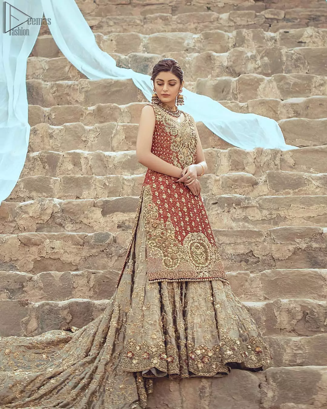An uplifting look for any formal occasion. This wedding outfit is emphasized with zardozi work. The shirt is beautifully decorated with embroidered neckline, a central geometric motif on the border, and scattered tiny floral motifs all over the ground. Pair it up with a pastel green back train lehenga enhancing with the art of classical heritage showcasing the craftsmanship of zardozi work, multiple colors embroidery, and finishing with scalloped borders. The outfit is coordinated with a net dupatta with hand-embroidered borders on all four sides and sequins spray on the ground.