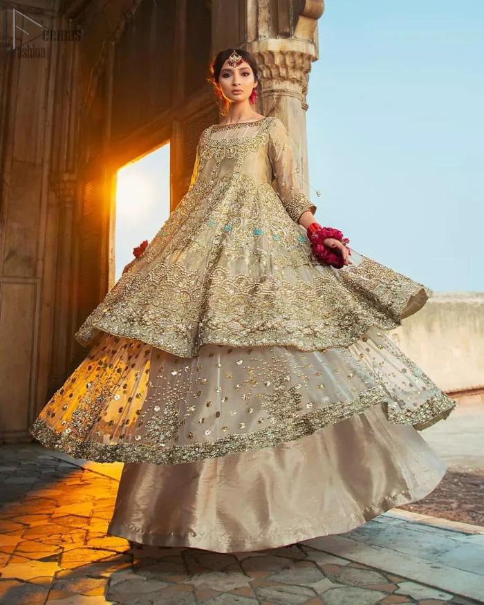 Pastel Green Double Layer Frock - Tea Rose Sharara. Fabulously stitched, Pastel Green double flared frock in maxi style is exquisite indeed. Fully embellished with tilla, dabka, sequins, pearls and silk thread embroidery. The frock body is entirely composed of pure organza with one part round neckline. Frock comes with three-quarter sleeves and it is concealed with a side zip closure. Tea rose pure tissue sharara with decently composed with fixed waist belt with side zip closure is one to wear on nikah or on a wedding day.
