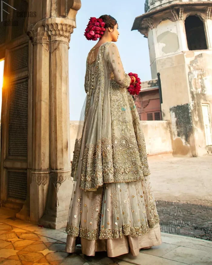 Pastel Green Double Layer Frock - Tea Rose Sharara. Fabulously stitched, Pastel Green double flared frock in maxi style is exquisite indeed. Fully embellished with tilla, dabka, sequins, pearls and silk thread embroidery. The frock body is entirely composed of pure organza with one part round neckline. Frock comes with three-quarter sleeves and it is concealed with a side zip closure. Tea rose pure tissue sharara with decently composed with fixed waist belt with side zip closure is one to wear on nikah or on a wedding day.