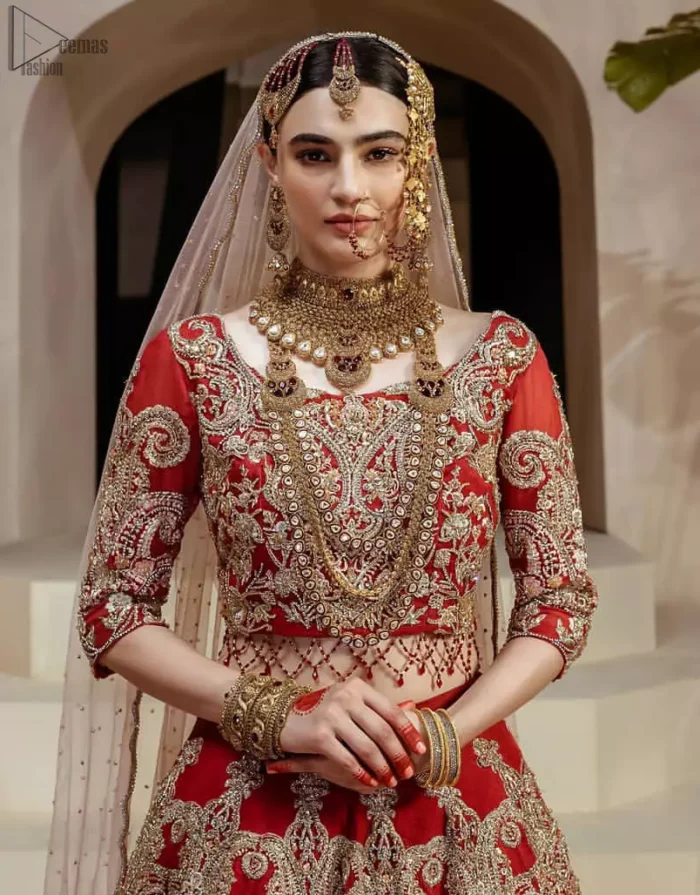 Crafted with love. This dress is classically designed to make your memorable day beautiful as it should be. This handcrafted remarkable ensemble reflects the aura of the heavenly blouse and includes art deco design elements. A wedding ensemble from the house of DeemasFashion in which the intricate detailing makes all the difference. A delicate arrangement of hand-embellished floral patterns with zardozi work makes the skirt more attractive. Complete the look with a maroon organza dupatta adorned with four-sided embellished borders and tiny floral motifs scattered all over the ground.