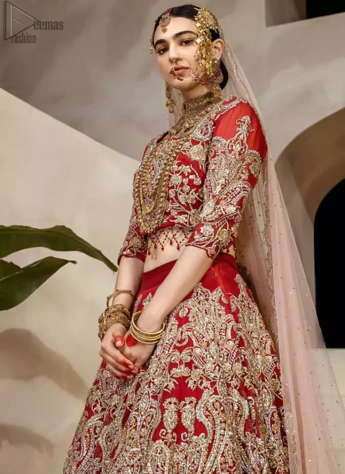 Crafted with love. This dress is classically designed to make your memorable day beautiful as it should be. This handcrafted remarkable ensemble reflects the aura of the heavenly blouse and includes art deco design elements. A wedding ensemble from the house of DeemasFashion in which the intricate detailing makes all the difference. A delicate arrangement of hand-embellished floral patterns with zardozi work makes the skirt more attractive. Complete the look with a maroon organza dupatta adorned with four-sided embellished borders and tiny floral motifs scattered all over the ground.