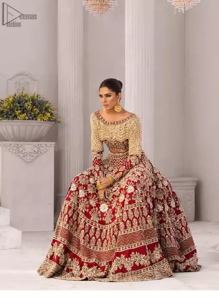 Discover classic red and fawn dresses for a traditional style, with delicate detailing and intricate accents for a subtle yet sophisticated look, including long-sleeves laden with zardozi work. The blouse is beautifully sculptured with floral embroidery, also adorned with cutwork, embellished with silver kora dabka, pearl and sequins work all over. Complement the look with a red lehenga emphasized with different sizes of floral motifs, geometric pattern and heavy embellished bottom with zardozi work is absolutely breathtaking. The outfit is to pair up with a red dupatta with hand embellished border and floral motifs all over.