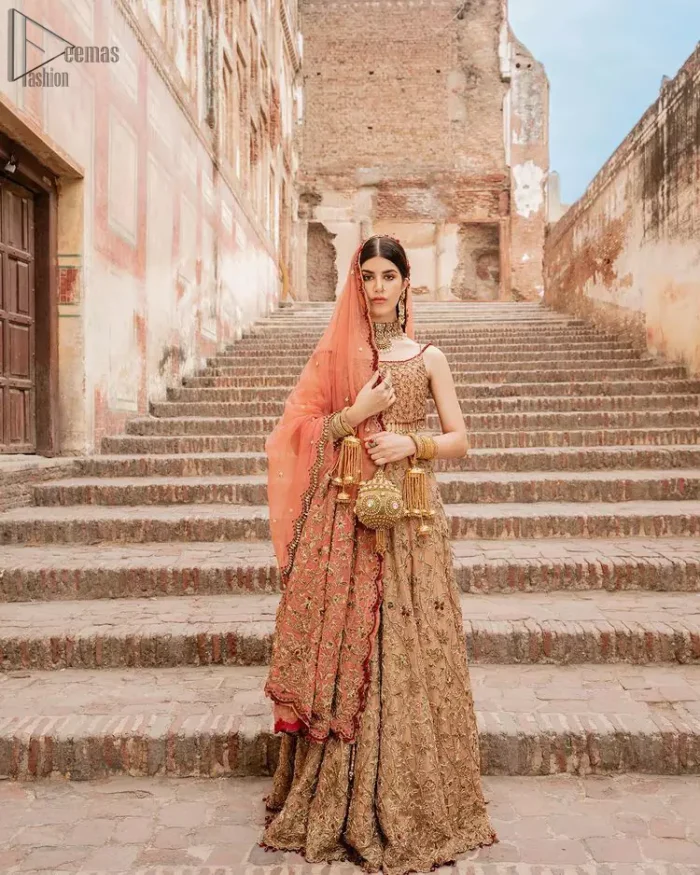 Crafted with love. This beautiful bride is a vision of impeccable grace and elegance in a divinely crafted bridal couture, with the exquisite embroideries that add the royal touch to the outfit. This off-shoulder blouse is meticulously crafted with zardozi work in the shades of golden and antique, finished the blouse with dangling tassels. The lehenga is emphasized with hand embellished floral embroidery with kora, dabka, tilla, sequins and beads all over. The look is complete when it gets paired up with an organza dupatta having scalloped finishing along the length and floral jaal on both sides of pallu.