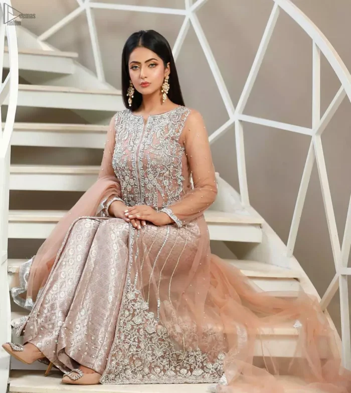 With pure fabric heavily embroidered with zardozi and the perfect blend of traditional flamboyance and modern elegance in design, you need to look no further for the perfect look for any formal occasion. The shirt is delicately crafted with silver zardozi work. The bodice is heavily laden with silver embellishment. Pair it up with tea rose palazzo pants scattered pearls on the bottom edge. The outfit is coordinated with net dupatta having kiran on all four sides.