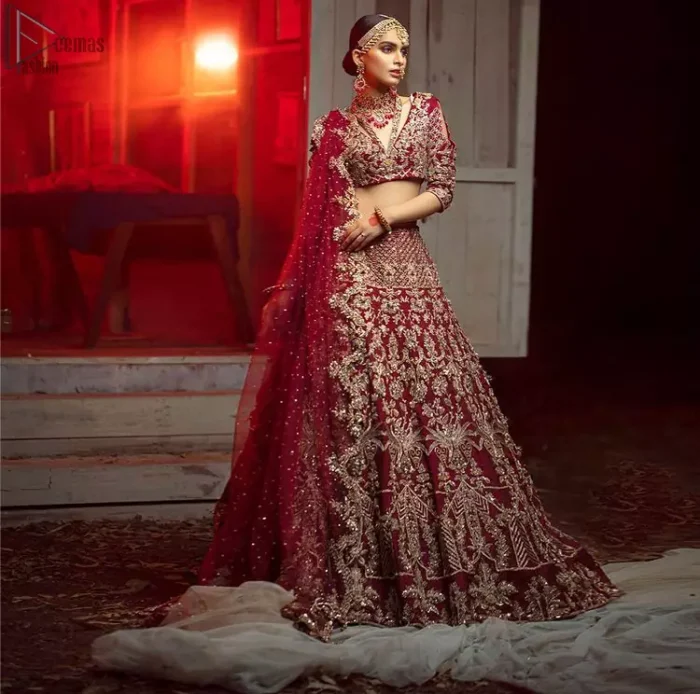 Maroon Pakistani bridal wear half blouse and lehenga comes with dupatta. Deep red half blouse choli along with same colour Lehenga of Organza Fabric with Golden-Ivory Embroidery is Everything. For a Bride planning, some exceptional outfit here comes the fully embellished, geometrical shapes having half sleeves for her Reception. The V-Neckline unifies the whole outfit with fully sprayed Tilla, Dabka work with floral motifs on Blouse Choli, Lehenga and Net Dupatta of Organza Fabric. The Lehenga has finished edges with full flare and fixed waist belt with a side zip closure along with dupatta of same deep red colour with heavy full embellished four borders.