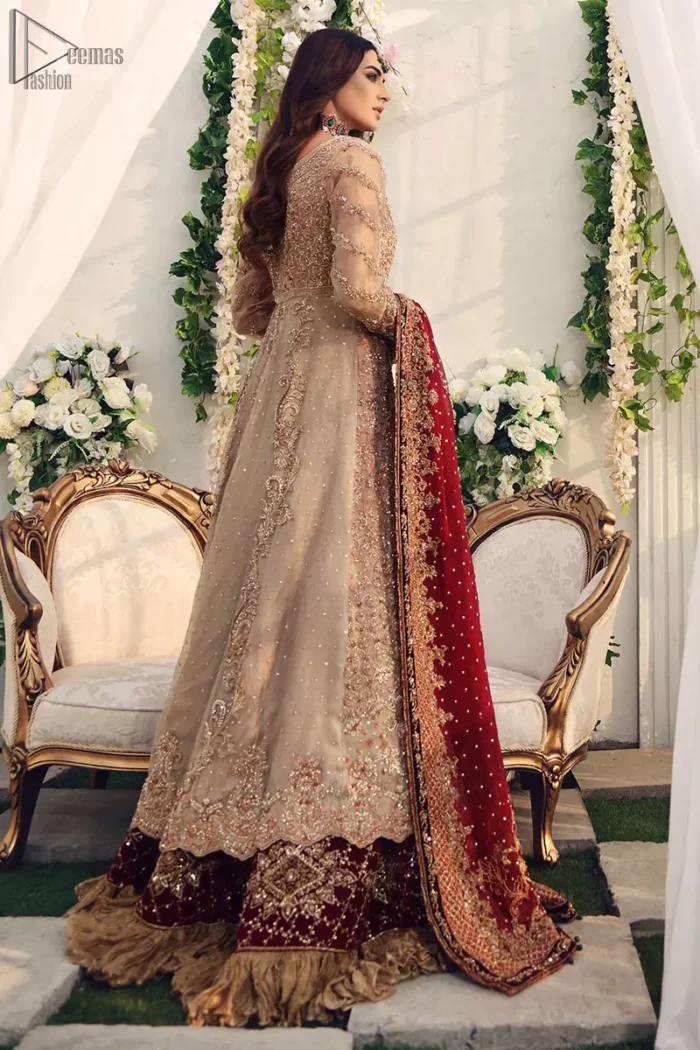This outfit should be the next addition to your wardrobe. Gussy up the glamour with this intricately embroidered fawn ensemble. Fully embroidered bodice accentuated with floral motifs and finished with scalp borders. Look breathtakingly stylish in this embroidered fawn front open pishwas. Pair it up with red banarsi lehenga furnished with maroon velvet applique and frilled border.  While the red dupatta with heavy work completely goes with fawn colour. This elegant ensemble turns timeless piece into a chic fantasy.