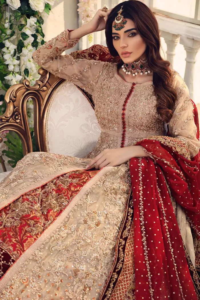 This outfit should be the next addition to your wardrobe. Gussy up the glamour with this intricately embroidered fawn ensemble. Fully embroidered bodice accentuated with floral motifs and finished with scalp borders. Look breathtakingly stylish in this embroidered fawn front open pishwas. Pair it up with red banarsi lehenga furnished with maroon velvet applique and frilled border.  While the red dupatta with heavy work completely goes with fawn colour. This elegant ensemble turns timeless piece into a chic fantasy.