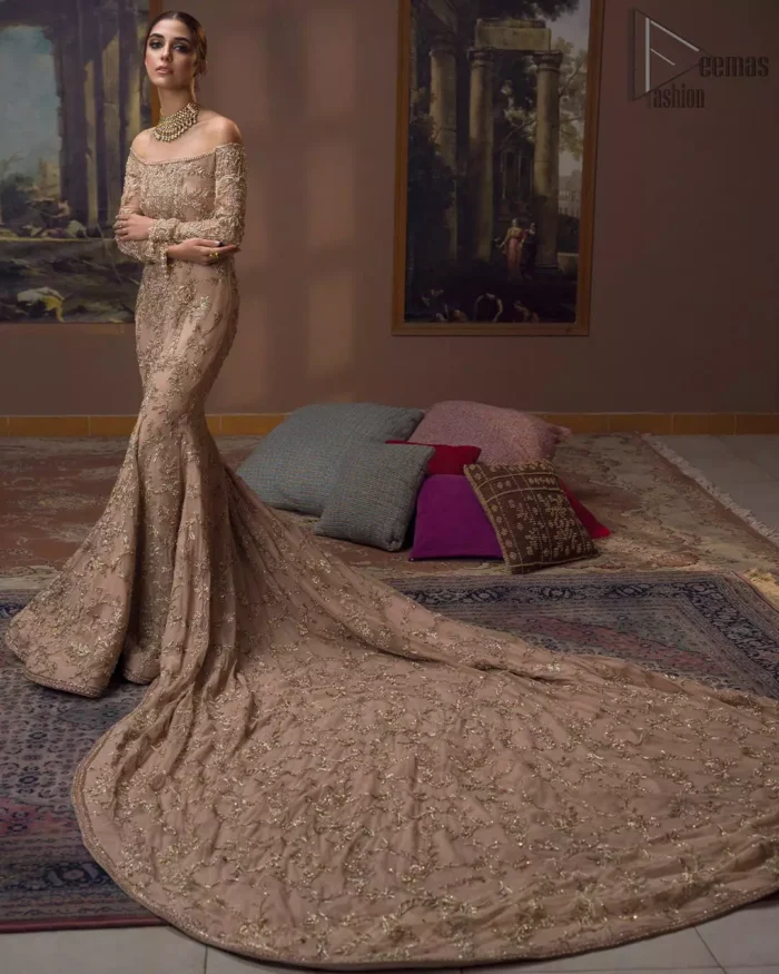Take a step towards refreshing your wardrobe with our fawn off-shoulder back train mermaid gown. The outfit is perfected with loaded golden and silver embroidery, elevated by vibrant floral motifs and adorned in a fawn embellished with golden work detailing around the strapless neckline. All over, this undeniably elegant attire will elevate your style. Feel the dreamy vibes with this heavenly combination of fawn off-shoulder back train mermaid gown and cigarette pants adorned with floral embroidery, followed by a graceful net dupatta. Making your evening parties more beautiful.
