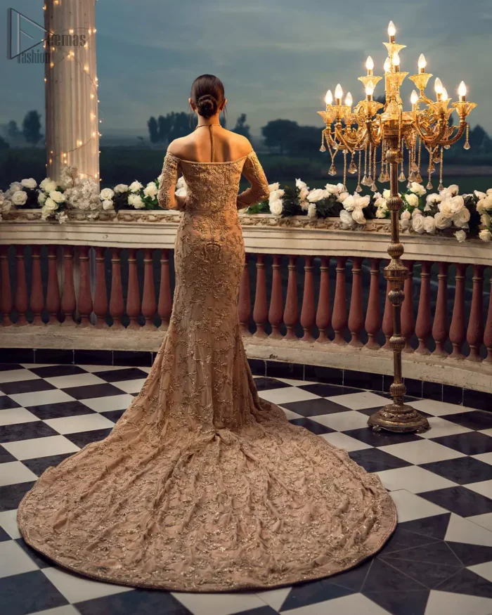 Take a step towards refreshing your wardrobe with our fawn off-shoulder back train mermaid gown. The outfit is perfected with loaded golden and silver embroidery, elevated by vibrant floral motifs and adorned in a fawn embellished with golden work detailing around the strapless neckline. All over, this undeniably elegant attire will elevate your style. Feel the dreamy vibes with this heavenly combination of fawn off-shoulder back train mermaid gown and cigarette pants adorned with floral embroidery, followed by a graceful net dupatta. Making your evening parties more beautiful.
