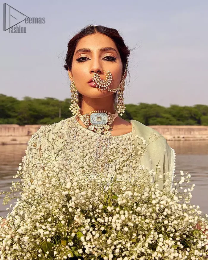 Glow up an evening formal event with a Light Parrot Green Gharara Shirt, a beautiful three-quartered sleeves shirt designed with the most accurate round neckline to make you appear the star of the night. But a star as beautiful as you need to sparkle bright, which is why the dress is adorned with an outstanding work of silver and gold embroidery and ornamented with glittering pearls. This beautiful dress is designed in a matching embellishment with criss-cross patterns to help you dress up precisely. Finally, an organza dupatta concludes your magical gorgeousness.