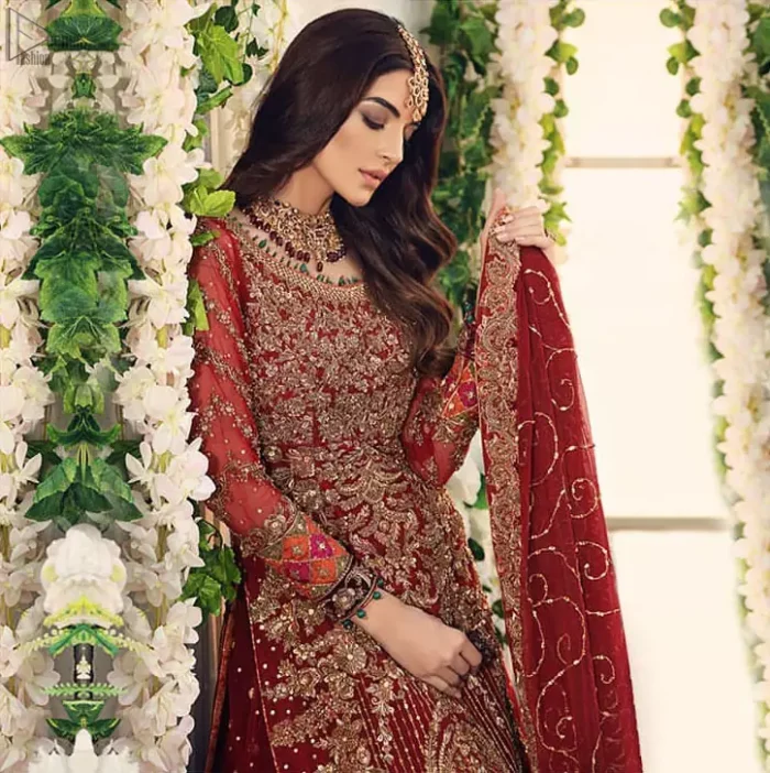 Bridal Wear Maroon Shirt n Dupatta – Chatta Patti Gharara. Framed in a Beautiful Shirt and Dupatta both in the same Maroon colour along Chatta Patti Lehenga is One To Wear. Multicolour copper embroidery on Shirt and Lehenga is fully embellishing with Appliques, Sequins, Tilla and Dabka work. Plus on Duppata too of Organza fabric same as that of Shirt and Lehenga which is fully sprayed with sequins and Tilla work. Along with finished edges and fixed waist belt with side zip closure. The shirt is with a round neckline and full Sleeves which are in full length; too completely engraved with embroidery plus floral motifs on Dupatta increasing the whole gorgeousness.