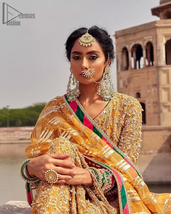 Presenting the Mustard Angrakha Frock, a charming Mehndi wear that will enhance your stunning personality to a whole new level. Made with pure organza, this mustard-coloured, full-sleeved frock comes with a graceful Chatta Patti Dupatta that perfects your looks. A beautiful touch of light golden embroidery embellished with sparkling pearls follows a fascinating churidar pajama, finally concluding the dress.