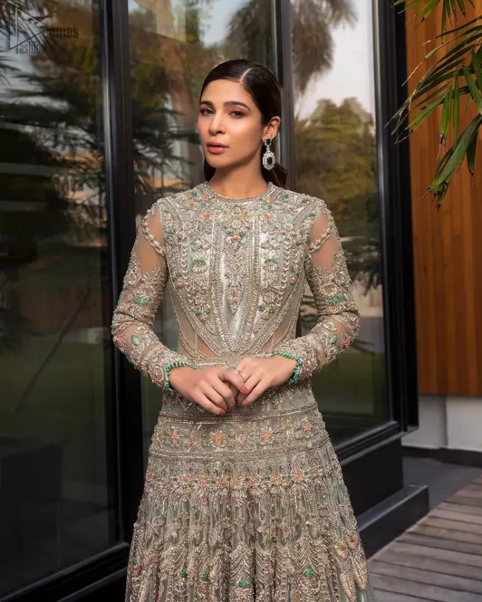 Pastel Green Large Flared Anarkali - Pakistani Wedding Gown. The bottom part of this amazing outfit comprises a lehenga with Fixed Waist Belt With Side Zip Closure. The Ivory i.e silver general embroidery with floral motifs and multicolour embroidery network on organza with finished embellished edges has its own impact. The Dupatta carried sideways have also tissue fabric with embellished four sides and finished edges. Whole this embellishment, the gorgeousness of the costume comes to the spectator noticing eye because of another unifying feature of this outfit that it is 100% imported, pure highest quality fabric.