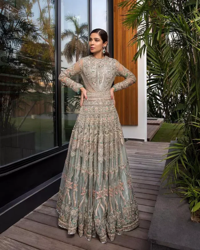 Pastel Green Large Flared Anarkali - Pakistani Wedding Gown. The bottom part of this amazing outfit comprises a lehenga with Fixed Waist Belt With Side Zip Closure. The Ivory i.e silver general embroidery with floral motifs and multicolour embroidery network on organza with finished embellished edges has its own impact. The Dupatta carried sideways have also tissue fabric with embellished four sides and finished edges. Whole this embellishment, the gorgeousness of the costume comes to the spectator noticing eye because of another unifying feature of this outfit that it is 100% imported, pure highest quality fabric.