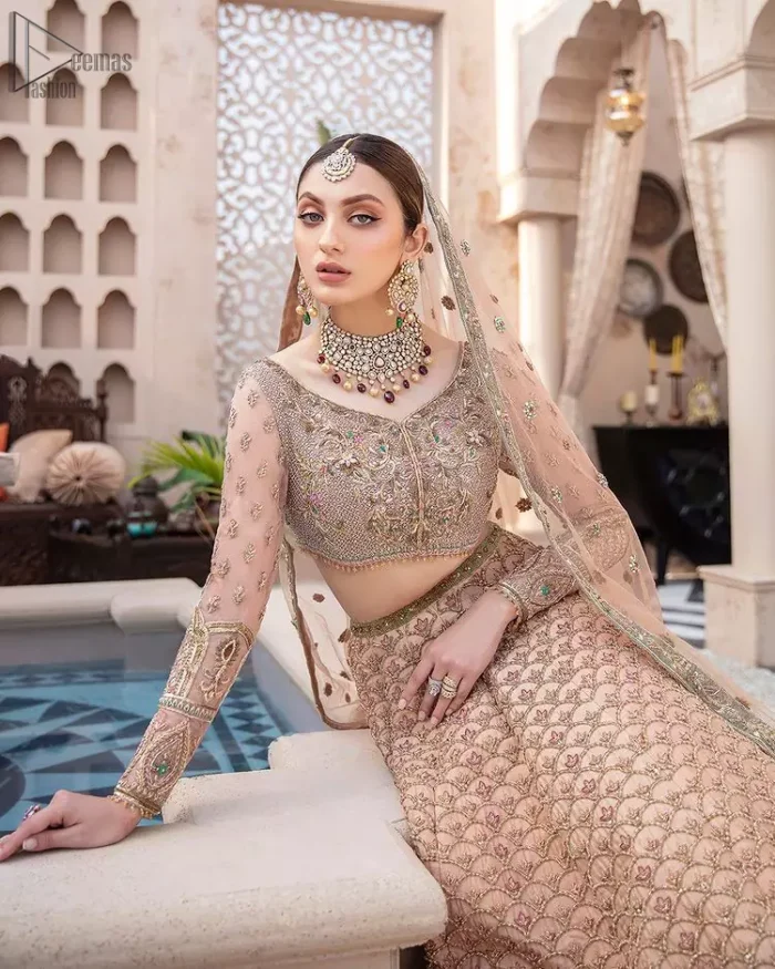 Pakistani Wedding Wear Peach Blouse Lehenga. DupattaThis breathtaking fit and flare wedding dress offers comfort without compromising on style. This nude peach colour is the perfect feminine and delicate shade with its meticulously crafted fabrication with gorgeous embroideries. The multiple colour embroidery The outfit comes with an embroidered belt. Adorned with sterling sequences and silver and crystal hand embellishments, it's a classic modern masterpiece!