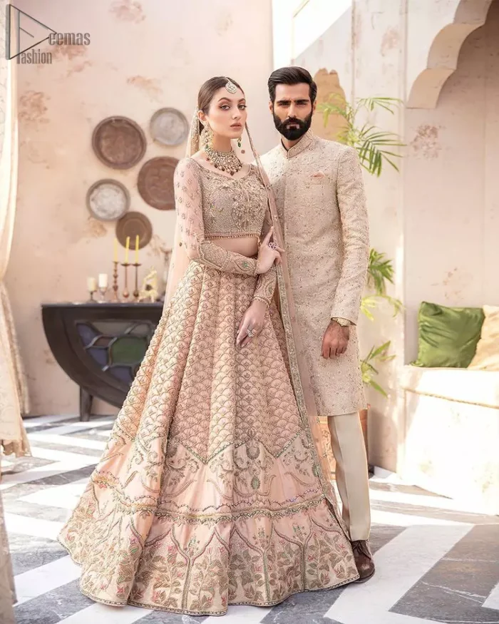 Pakistani Wedding Wear Peach Blouse Lehenga. DupattaThis breathtaking fit and flare wedding dress offers comfort without compromising on style. This nude peach colour is the perfect feminine and delicate shade with its meticulously crafted fabrication with gorgeous embroideries. The multiple colour embroidery The outfit comes with an embroidered belt. Adorned with sterling sequences and silver and crystal hand embellishments, it's a classic modern masterpiece!