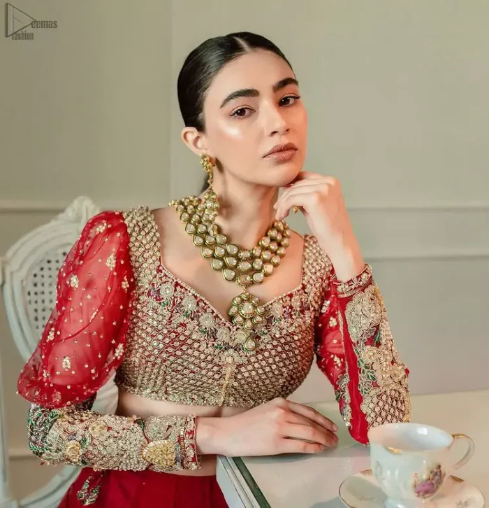 The red Lehenga Blouse comes with full sleeves and is made with the purest organza, while a sweetheart neckline follows mesmerizing light golden embroidery, giving the dress a touch of glamour. A perfect treat to your reception day. Red Blouse – Solid Embroidered Lehenga Reception Day.