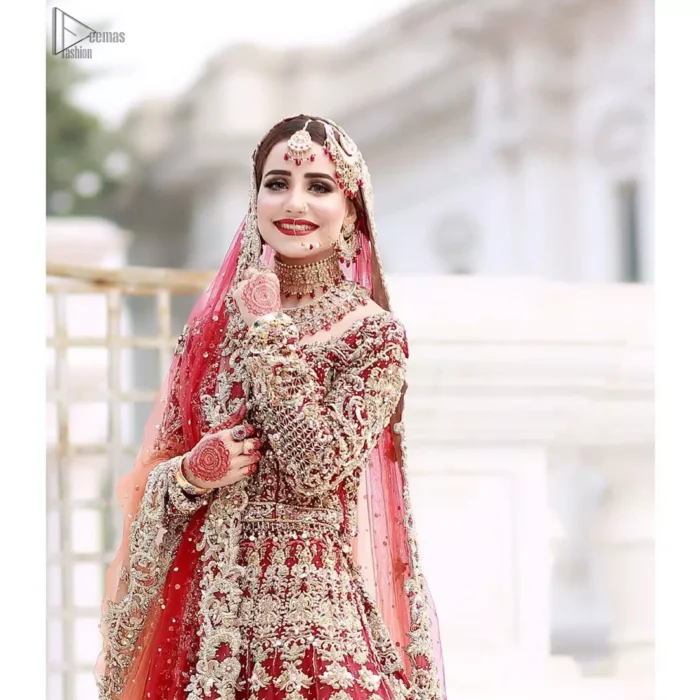 This bridal outfit is perfect for your unforgettable day. This exceptionally detailed dress is cut in a seductive fit and flare silhouette that’s sure to turn heads. Featuring a delicately embellished neckline highlighted with zardozi detailing and intricately embroidered borders. This technique gives our garments a unique look and helps to sustain a traditional craft carried out by skilled artisans across Asia. The lehenga is heavily laden with golden kora, dabka, tilla, sequins and beads work and also beautified with scalloped borders. Pair it up with heavily embroidered organza dupatta that gives the right amount of glamour to the outfit.