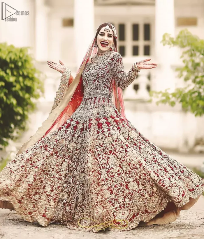 This bridal outfit is perfect for your unforgettable day. This exceptionally detailed dress is cut in a seductive fit and flare silhouette that’s sure to turn heads. Featuring a delicately embellished neckline highlighted with zardozi detailing and intricately embroidered borders. This technique gives our garments a unique look and helps to sustain a traditional craft carried out by skilled artisans across Asia. The lehenga is heavily laden with golden kora, dabka, tilla, sequins and beads work and also beautified with scalloped borders. Pair it up with heavily embroidered organza dupatta that gives the right amount of glamour to the outfit.