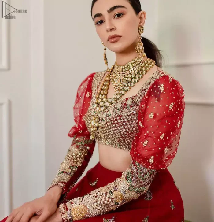 The red Lehenga Blouse comes with full sleeves and is made with the purest organza, while a sweetheart neckline follows mesmerizing light golden embroidery, giving the dress a touch of glamour. A perfect treat to your reception day. Red Blouse – Solid Embroidered Lehenga Reception Day.
