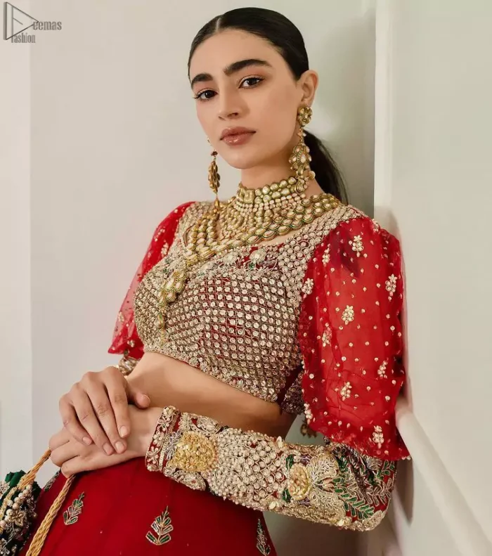 The red Lehenga Blouse comes with full sleeves and is made with the purest organza, while a sweetheart neckline follows mesmerizing light golden embroidery, giving the dress a touch of glamour. A perfect treat to your reception day. Red Blouse – Solid Embroidered Lehenga Reception Day.