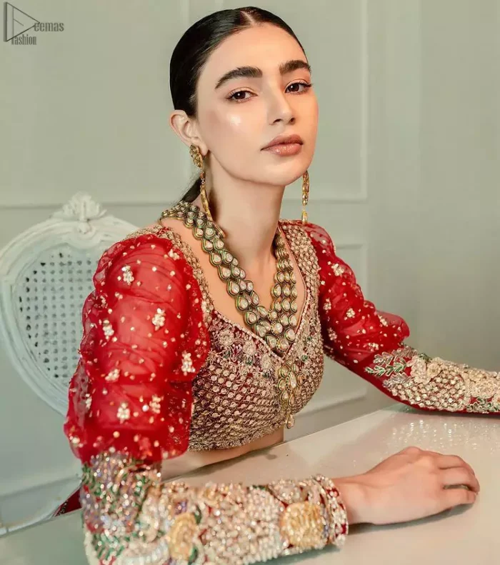 The red Lehenga Blouse comes with full sleeves and is made with the purest organza, while a sweetheart neckline follows mesmerizing light golden embroidery, giving the dress a touch of glamour. A perfect treat to your reception day. Red Blouse – Solid Embroidered Lehenga Reception Day.