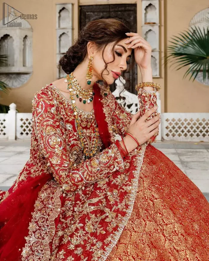 Red Bridal Peplum n Dupatta – Orange Lehenga. Red peplum with pure organza and fully engraved multi colour embroidery is such an eye-catching masterpiece that you would like to wear on your big day. Silver and golden combination of embellishment along with red pearls, Tilla Dabka, Appliques, Sequins and Zardozi work mainly gives such an eye feasting outfit to wear. The rounded, neckline and full sleeves give it a proper finishing in a beautiful attractive peplum style with Kattan Banarsi Jamawar exquisite Lehenga. With a concealed side zip closure along with floral motifs having finished edges. The Red organza dupatta has four-sided embellished borders.