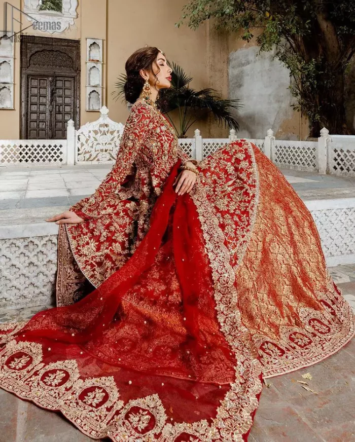 Red Bridal Peplum n Dupatta – Orange Lehenga. Red peplum with pure organza and fully engraved multi colour embroidery is such an eye-catching masterpiece that you would like to wear on your big day. Silver and golden combination of embellishment along with red pearls, Tilla Dabka, Appliques, Sequins and Zardozi work mainly gives such an eye feasting outfit to wear. The rounded, neckline and full sleeves give it a proper finishing in a beautiful attractive peplum style with Kattan Banarsi Jamawar exquisite Lehenga. With a concealed side zip closure along with floral motifs having finished edges. The Red organza dupatta has four-sided embellished borders.
