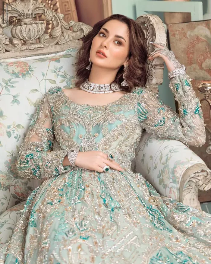 This style-savvy bride totally pulled off our classic bridal wear with unmatchable grace-giving major bridal goals. Featuring beautiful handwork, this outfit has a delicate arrangement of hand-embellished floral patterns with pearls and crystals along the length. Refined craftsmanship is at its best with hand embellished zardozi work elegantly all over the outfit. Frilled on the bottom of the maxi makes the outfit look like nothing but a dream. This outfit is paired with an organza dupatta with embroidered border and raw silk churidar pajama, making it a statement piece.