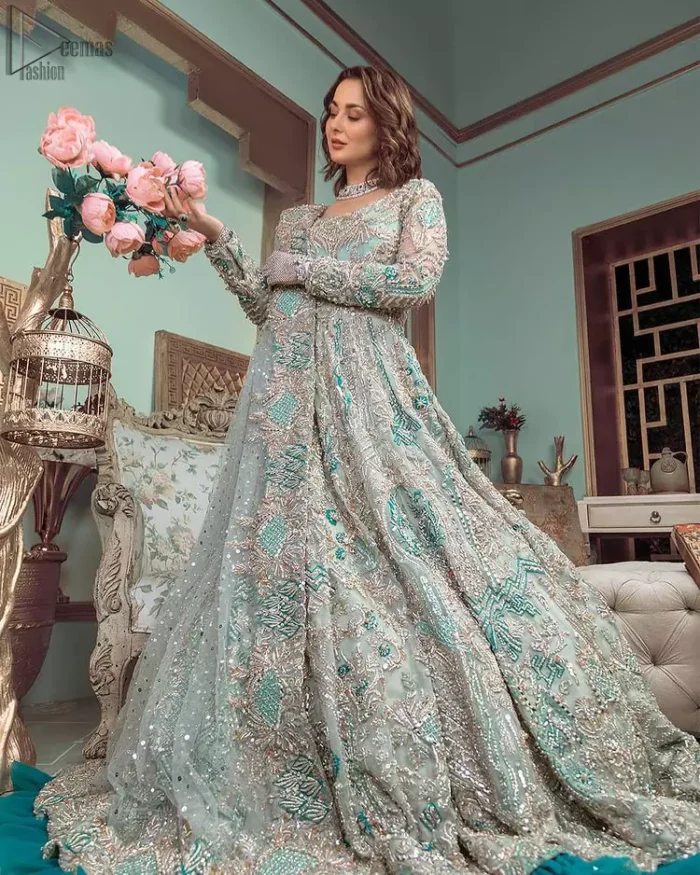 This style-savvy bride totally pulled off our classic bridal wear with unmatchable grace-giving major bridal goals. Featuring beautiful handwork, this outfit has a delicate arrangement of hand-embellished floral patterns with pearls and crystals along the length. Refined craftsmanship is at its best with hand embellished zardozi work elegantly all over the outfit. Frilled on the bottom of the maxi makes the outfit look like nothing but a dream. This outfit is paired with an organza dupatta with embroidered border and raw silk churidar pajama, making it a statement piece.