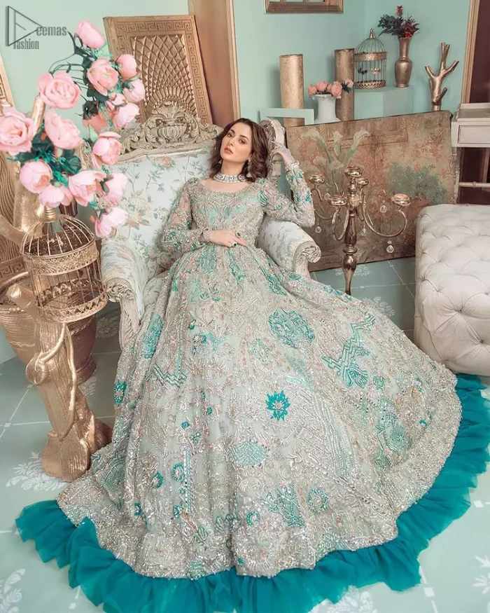 This style-savvy bride totally pulled off our classic bridal wear with unmatchable grace-giving major bridal goals. Featuring beautiful handwork, this outfit has a delicate arrangement of hand-embellished floral patterns with pearls and crystals along the length. Refined craftsmanship is at its best with hand embellished zardozi work elegantly all over the outfit. Frilled on the bottom of the maxi makes the outfit look like nothing but a dream. This outfit is paired with an organza dupatta with embroidered border and raw silk churidar pajama, making it a statement piece.