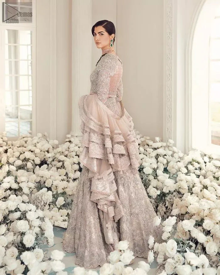 Your wedding day becomes more memorable when the guests are stunned by your majestic beauty and the perfect arrangements that are made. The Cream Lehenga Blouse is designed with such dexterity as to make you one gorgeous-looking bride on your big day. The dress code demands a full-sleeved blouse with a unique sweetheart neckline. Its exquisite fawn color is meritoriously adorned with superb silver embroidery and stylish tassels, which are indeed the most graceful works of matching embellishment. When it comes to the definition of elegance, the purest organza is specifically reserved for the creation of such marvelous attire. Followed by a beautiful dupatta and a lehenga, this charming bridal wear will make your Walima or Nikkah a heavenly day.