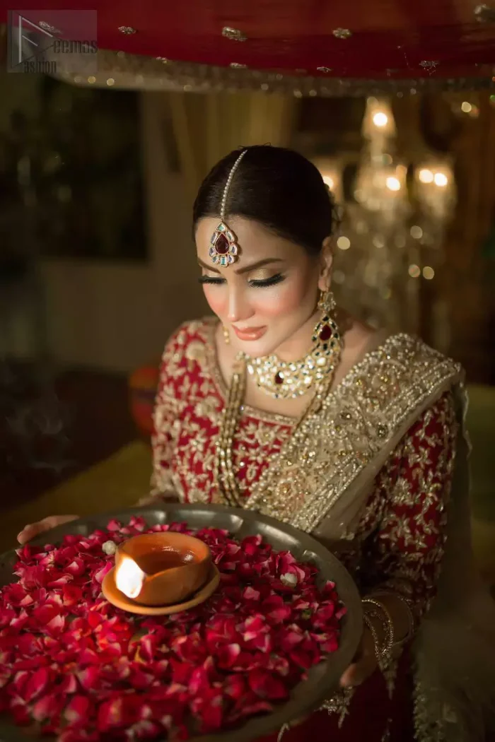 Looking perfectly gorgeous is not a mere utopia. You already appear stunning but with the Crimson Lehenga Blouse on you, things will definitely get unimaginably beautiful. A marvellous combination of a three-quarter sleeved Crimson blouse choli, an elegant lehenga and a tan net dupatta, dazzle up the dress with unexplainable enchantment. The attire features a heavy centre panel and a mesmerizing round neckline, designed with skill and accuracy. To add more to its exquisiteness, a fascinating work of golden embroidery follows an outstanding adornment of floral motifs. Graceful as it is, pure organza blooms its meritoriousness, making the dress a whole treat to your reception day.