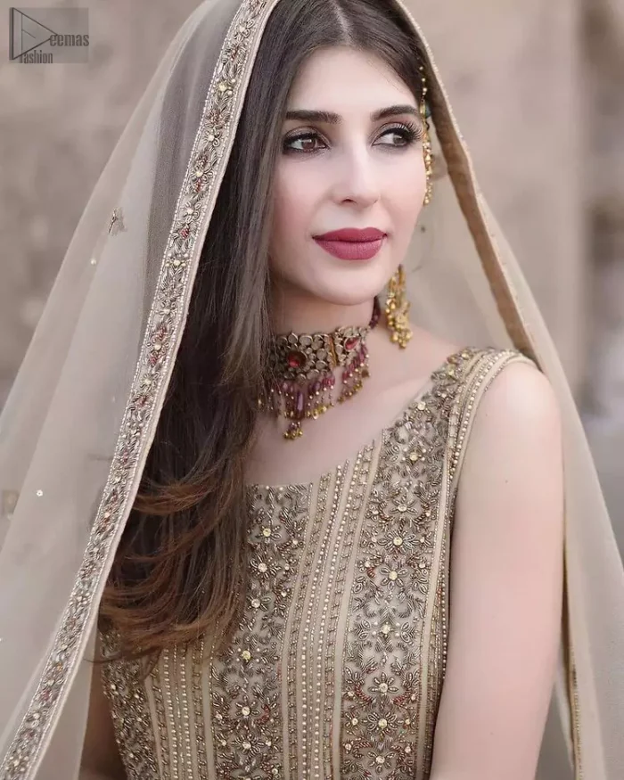 Captured in a traditional silhouette, this bridal wear stands out due to its uniqueness, the perfect fusion of modern cut and traditional embroidery. The Beige Long Shirt Sharara is beautifully decorated with heavy embroidery and adorned with kora, dabka, tilla, sequins and pearls. It comes with pure chiffon sharara, followed by organza dupatta which is sprinkled with sequins all over it. It is further furnished with a one-sided border. This marvellous attire will beautify your looks on your memorable Nikkah day.