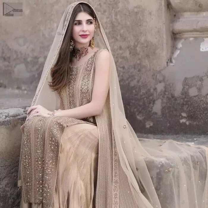 The Beige Long Shirt Sharara is beautifully decorated with heavy embroidery and adorned with kora, dabka, tilla, sequins and pearls.