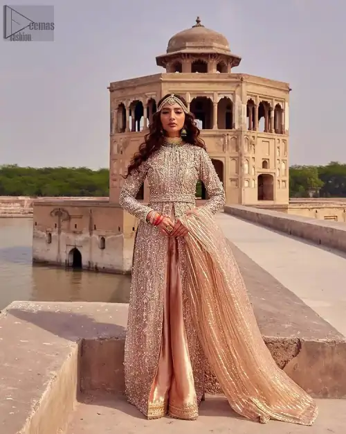 the dress with a tissue dupatta and graceful palazzo pants makes you the center of attention on your big day. Peach