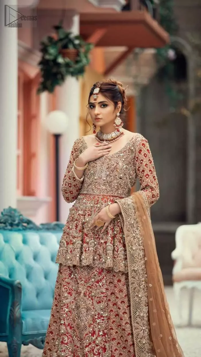Red Peplum and Lehenga with Rust Net Dupatta. It features a highly remarkable back train and is decorated with fascinating criss-cross patterns. charming as it is, the very exquisite dress code includes a mesmerizing organza peplum, a gorgeous organza lehenga and not to forget, the traditional touch with a net dupatta. 