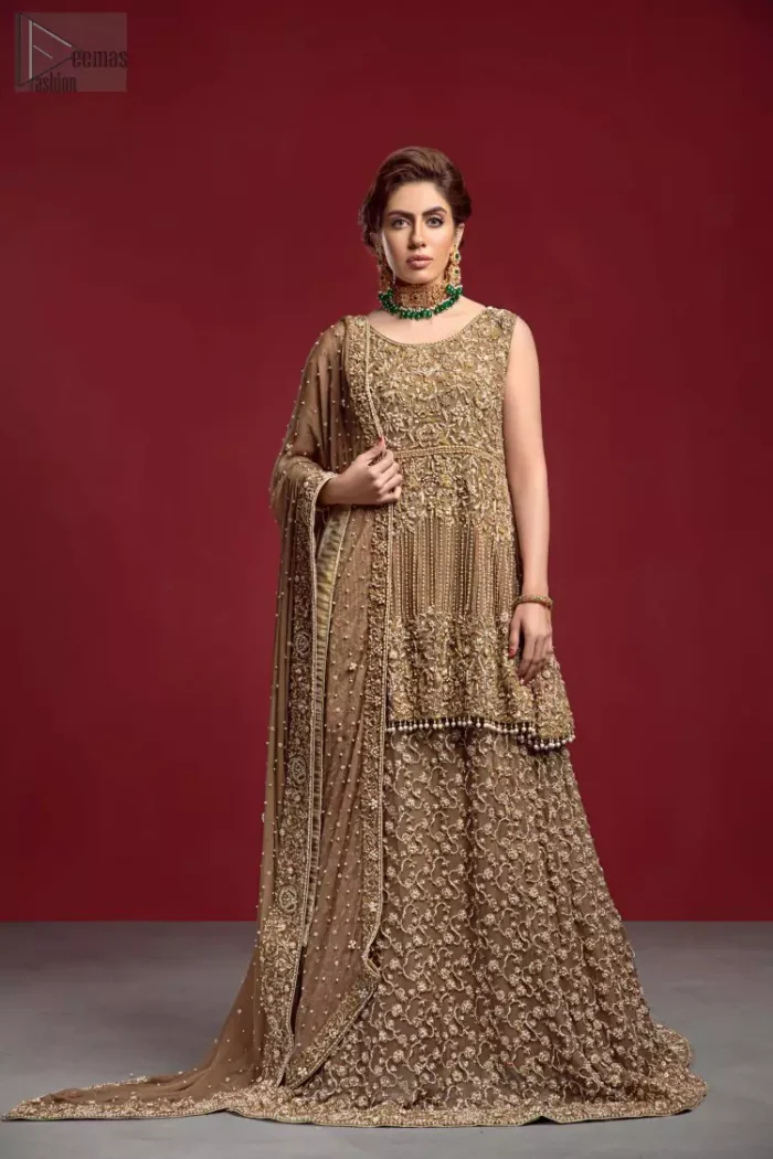 Captured in a traditional silhouette, The bridal stands out due to its uniqueness and the perfect fusion of modern cut and traditional embroidery. This dress is beautifully decorated with heavy embroidery. It is highlighted with kora, dabka, tilla, sequins and pearls. The peplum is enhanced with zardosi work all over and tassels on the hemline. It comes with a full embellished lehenga adorned with a fully embellished back train. It is coordinated with an organza dupatta which is sprinkled with pearls all over it. It is further furnished with a four-sided embroidered border.