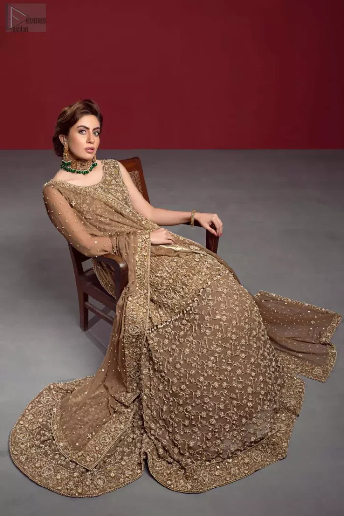 Captured in a traditional silhouette, The bridal stands out due to its uniqueness and the perfect fusion of modern cut and traditional embroidery. This dress is beautifully decorated with heavy embroidery. It is highlighted with kora, dabka, tilla, sequins and pearls. The peplum is enhanced with zardosi work all over and tassels on the hemline. It comes with a full embellished lehenga adorned with a fully embellished back train. It is coordinated with an organza dupatta which is sprinkled with pearls all over it. It is further furnished with a four-sided embroidered border.